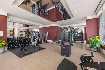 a gym with a lot of treadmills and machines at Modern Studio w Skyline Views by Bayfront Park in Miami