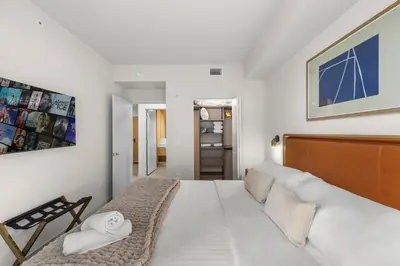 a bedroom with a large white bed in a room at Downtown lifestyle - Luxury condo & Rooftop Pool in Miami