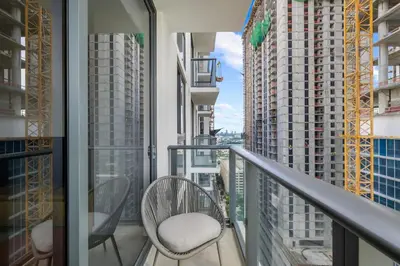 a balcony with two chairs and some tall buildings at Downtown lifestyle - Luxury condo & Rooftop Pool in Miami