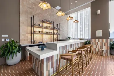a restaurant with a bar with stools at Downtown lifestyle - Luxury condo & Rooftop Pool in Miami