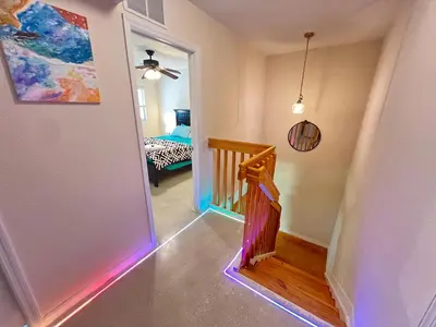 a hallway with a stairway with a rainbow light at Queen with Private Dedicated Spa Bath in Miami
