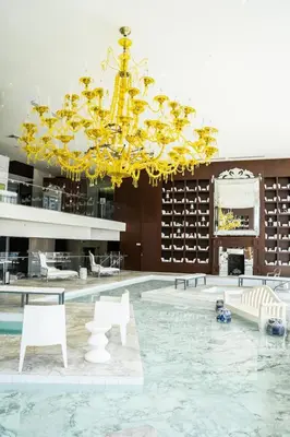 a large lobby with a large chandelier and white chairs at Brickell 35th Floor Residence with Saltwater Pool 5-Star Amenities in Miami