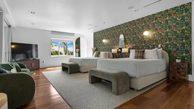 a living room with two beds and a television at Jungle Penthouse Private Pool in South Beach in Miami Beach