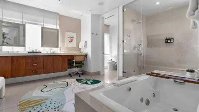 a large bathroom with a tub and a sink at Jungle Penthouse Private Pool in South Beach in Miami Beach