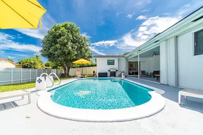 a swimming pool in the backyard of a house at Large corner Villa with Pool Table and Private Pool in Hollywood