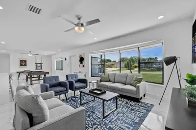 a living room with two couches and a table at Large corner Villa with Pool Table and Private Pool in Hollywood