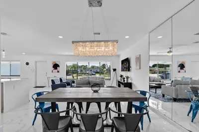 a dining room with a large wooden table and chairs at Large corner Villa with Pool Table and Private Pool in Hollywood
