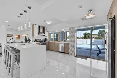 a kitchen and dining room with a view of a pool at Large corner Villa with Pool Table and Private Pool in Hollywood