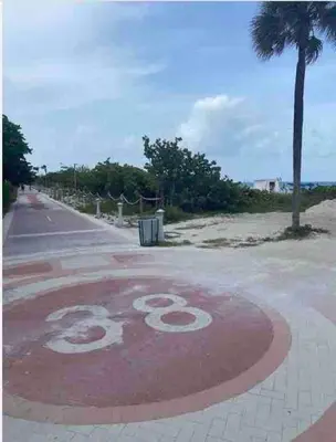 a sign on a road next to a beach at Waterviews studio at the beach #mybeachspotmiami in Miami Beach