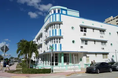 a white building with blue accents on a street at Waterviews studio at the beach #mybeachspotmiami in Miami Beach