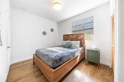 a bedroom with a bed and a window at Retro Miami RareFREE Parking 1 Min to Beach in Miami Beach