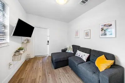 a living room with a couch and a flat screen tv at Retro Miami RareFREE Parking 1 Min to Beach in Miami Beach