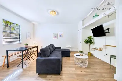 a living room with a couch and a table at Steps from Ocean Art Deco 1BR & Free Parking in Miami Beach