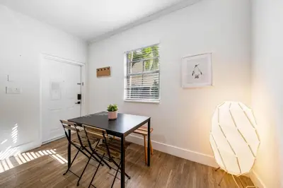 a dining room with a table and a window at Steps from Ocean Art Deco 1BR & Free Parking in Miami Beach