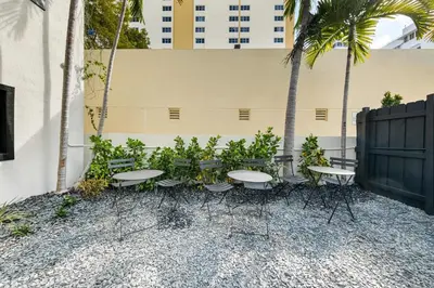 a group of tables and chairs in front of a building at Steps from Ocean Art Deco 1BR & Free Parking in Miami Beach