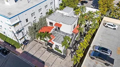 an overhead view of a house with palm trees at Art Deco Escape Steps to Ocean & Free Parking in Miami Beach