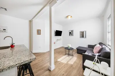 a living room with a couch and a table at Art Deco Escape Steps to Ocean & Free Parking in Miami Beach