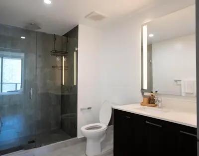 a bathroom with a shower and a toilet and a sink at Downtown Miami 2BR Retreat - Walk to Bayside & Port - Sleeps 6 in Miami
