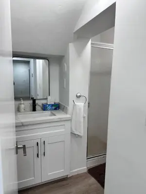 a white bathroom with a sink and a mirror at CG Miami House in Miami