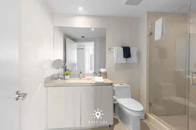 a bathroom with a sink and a toilet and a shower at Oceanline 3BR Corner Balcony & Calm Seas in Hollywood