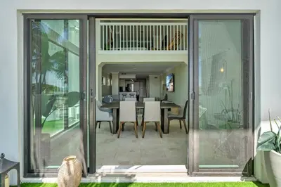 a dining room with glass doors and a table at Beachfront Apartment in Miami Beach at the Casablanca Hotel in Miami Beach