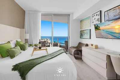 a bedroom with a bed and a view of the ocean at Insane Ocean View Balcony - Beachfront Resort & Pool in Hollywood
