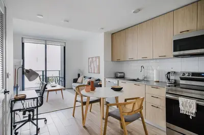 a kitchen and living room with a table and chairs at Blueground Coral Gables pool wd nr Vizcaya MIA-125 in Miami