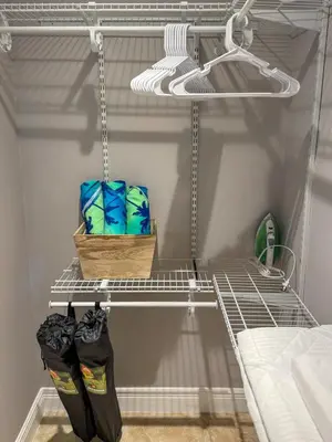 a shelf in a closet with two bags on it at 20 Off The Jungle House 10 min Beach & FLL Airport in Fort Lauderdale