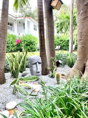 a garden with a statue of a head in a yard at B08 10 MIN FROM MIAMI BEACH, Studio, Miami Design District & Wynwood in Miami