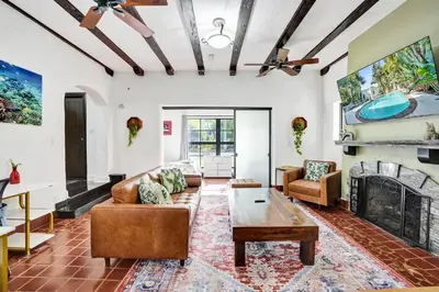 a living room with a couch and a fireplace at Spanish 5 Bedroom Pool House Minutes to the Beach in Hollywood