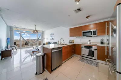 a kitchen with a sink and a stove top oven at Midtown Miami Marvel- Heated Pool & Prime Location in Miami