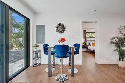 a living room with a table and blue chairs at Cute 3 Bedroom 2 Bathroom Pool Home in Hollywood