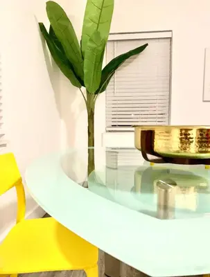 a glass table with a plant on top of it at B10 7 MIN FROM MIAMI BEACH, 1 Bed Apartment, Design District & Wynwood in Miami