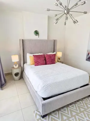a bedroom with a large bed with pink pillows at Stylish Condo with Panoramic Ocean Views in Miami
