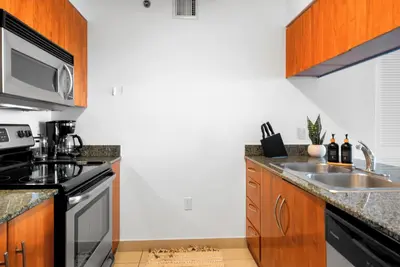 a kitchen with a sink and a stove at Stylish Condo with Panoramic Ocean Views in Miami