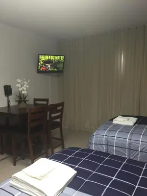 a room with a bed and a table and a television at Ocean Front Resort Studio in Miami Beach