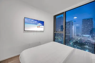 a white bedroom with a large window and a bed at Amazing property in Miami