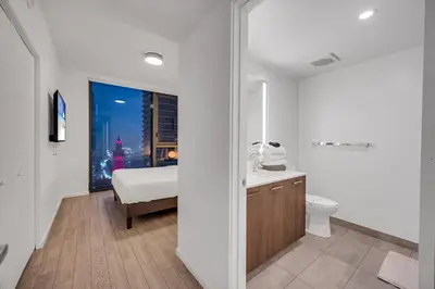 a bathroom with a bed and a toilet and a window at Amazing property in Miami