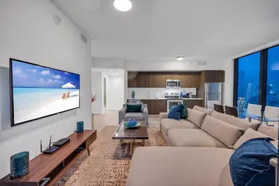 a living room with a couch and a tv on a wall at Amazing property in Miami