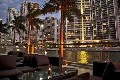 a restaurant with palm trees and a view of a city at Newly Renovated 1BR Brickell Condo plus Parking in Miami
