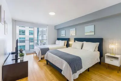 a bedroom with two beds and a large window at Newly Renovated 1BR Brickell Condo plus Parking in Miami