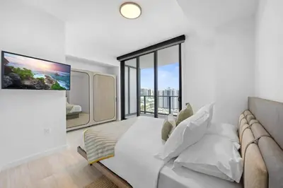 a white room with a couch and a large window at NOK Classy 2BR in Miami Beach in Miami Beach