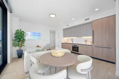 a kitchen and living room with a table and chairs at NOK Classy 2BR in Miami Beach in Miami Beach