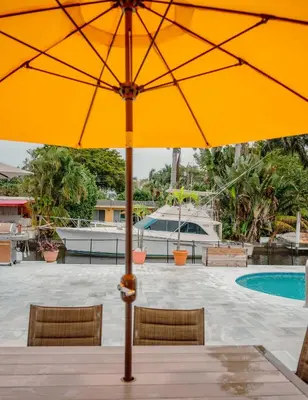a yellow umbrella sitting on top of a table at Bimini Bliss Waterfront Pool Retreat in Fort Lauderdale