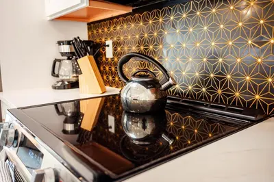 a tea kettle sitting on top of a stove in a kitchen at Bimini Bliss Waterfront Pool Retreat in Fort Lauderdale