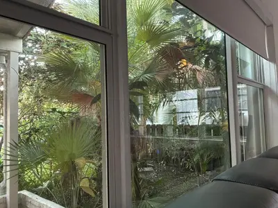 a sliding glass door with a view of a garden at Private House Beach in Miami Beach