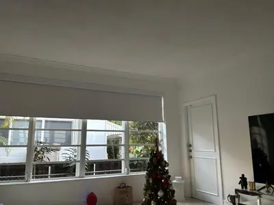 a christmas tree in a living room with a window at Private House Beach in Miami Beach
