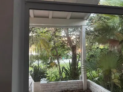 a window in a house looking out at a garden at Private House Beach in Miami Beach
