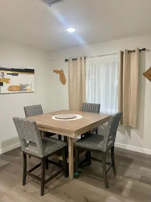 a wooden table and chairs in a room at New 3BR in Central Miami Location for Family & Groups in Miami