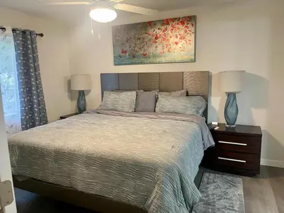 a bedroom with a bed with two lamps and a painting at New 3BR in Central Miami Location for Family & Groups in Miami